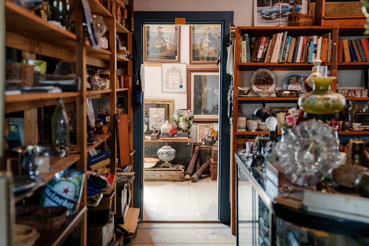 Warm antique shop interior filled with vintage curios and furniture, inviting exploration and discovery